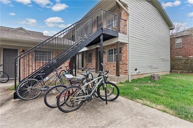 View of side of home featuring a yard, fence, a ba