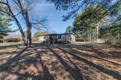 Mature shade trees dot the front yard.