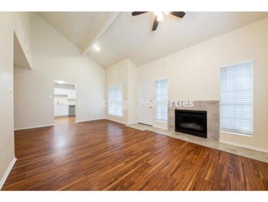 Unfurnished living room featuring baseboards, a h