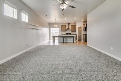 Unfurnished living room featuring ceiling fan with