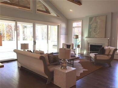 Stunning family room with beamed ceiling opens to 