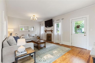 Living room features wood floors, gas fireplace, natural light.
