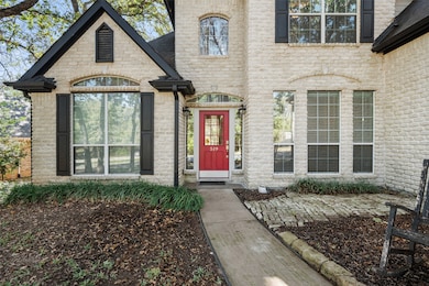 View of exterior entry with brick siding and stone siding