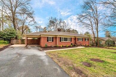 Front view of home showcasing 1-car carport and pa