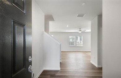 Entrance foyer with baseboards, dark wood-type flooring, a ceiling fan, stairs, and recessed lighting