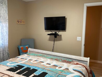 Bedroom with wood finished floors and baseboards