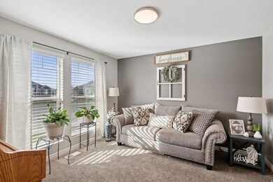 Carpeted living room with baseboards