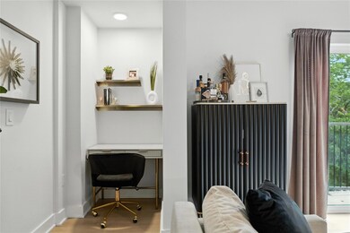 Home office featuring wood finished floors and ba