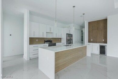 Kitchen with white cabinets, decorative light fixt