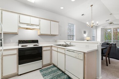 Kitchen featuring hanging light fixtures, white ap