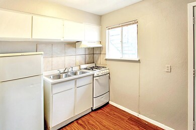Kitchen with white appliances, light wood-type fl