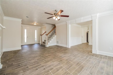 Foyer entrance featuring visible vents, stairway, 