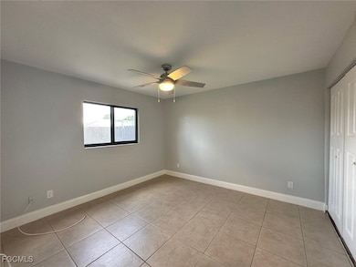 Unfurnished bedroom featuring ceiling fan and light tile patterned floors