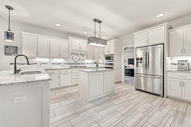 Gorgeous kitchen with granite countertops, stainless appliances, central vaccuum, large pantry, island, gas cooktop, & fireplace.