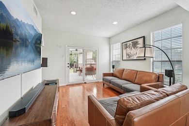 Living room featuring a textured ceiling, light w