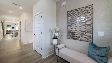 Hall featuring wood finished floors, baseboards, recessed lighting, and an accent wall