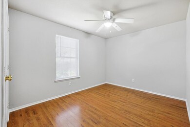 Empty room with ceiling fan and hardwood / wood-style floors