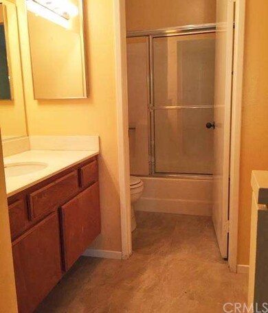 Master bath with tiled floor and alcove for dresse