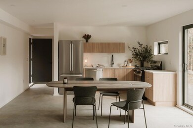 Kitchen with modern cabinets, appliances with stainless steel finishes, and light brown cabinetry