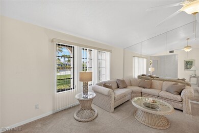 Living room with a ceiling fan, carpet flooring, a