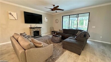 Living area featuring baseboards, a fireplace, a c