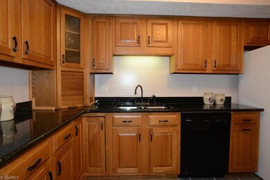 Chef-friendly kitchen with granite counters and bronze-finished hardware.