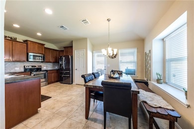 Kitchen featuring appliances with stainless steel