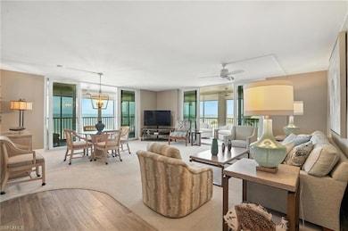Living room with light wood-style floors, a wall of windows, and ceiling fan - Virtually Edited Image