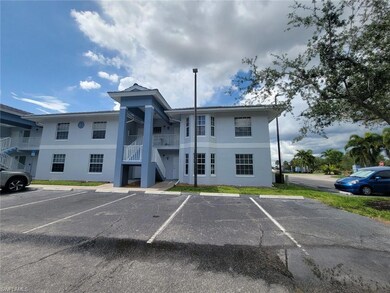 View of property featuring stairs and uncovered parking