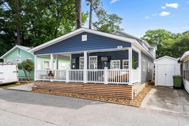 View of front of house featuring a storage unit, a