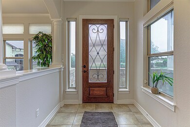 Foyer entrance with decorative columns, baseboard