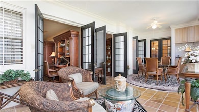 Living area featuring french doors, tile patterned