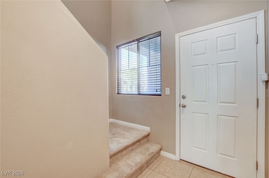 Foyer entrance with light tile patterned flooring,