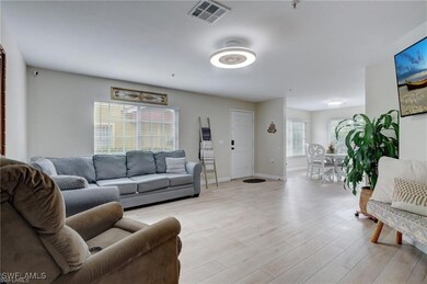 Living room with light hardwood / wood-style floor