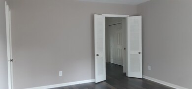 Living room french doors open to kitchen