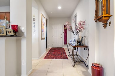 Hallway featuring light tile patterned flooring