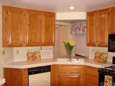 VIEW OF BRIGHT CHEERY KITCHEN. PASS THRU WINDOW TO