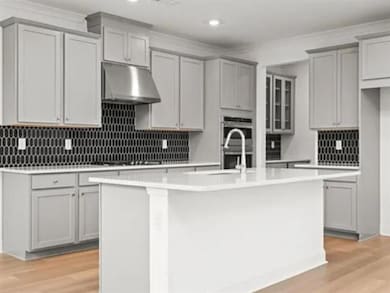 Kitchen featuring light countertops, gray cabinets