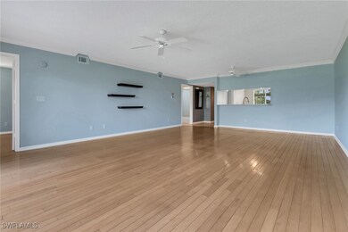 Unfurnished living room featuring ceiling fan, orn