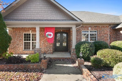 Peaceful mornings await on the east-facing covered front porch. All outside doors and pillars freshly painted Fall 2025!