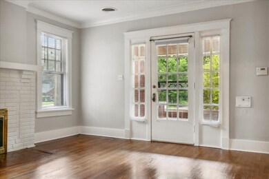 Doorway to outside with crown molding, dark wood-t