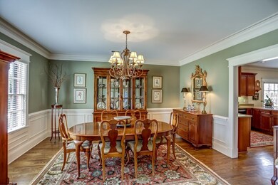Formal dining room is enhanced by lovely molding &