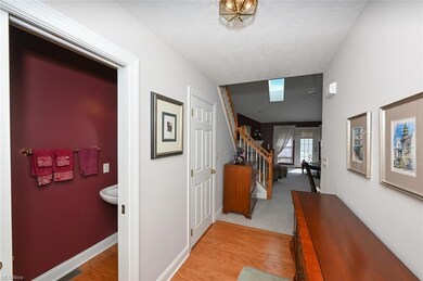 Hallway featuring a textured ceiling and light har