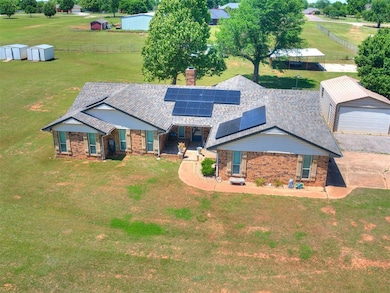 View of front facade with an outbuilding, brick si