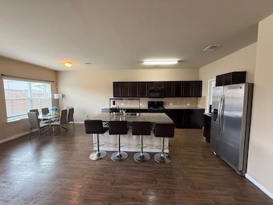 Kitchen featuring stainless steel fridge with ice