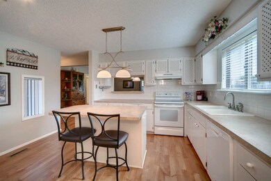 Wood floors, big Island with seating.