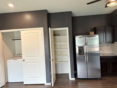 Kitchen featuring washer / clothes dryer, stainle