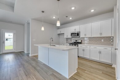 Kitchen featuring sink, hanging light fixtures, wh