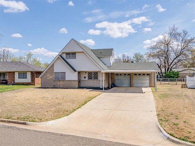View of front facade featuring fence, driveway, a 