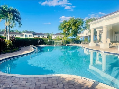 Community pool featuring a patio area and a residential view
